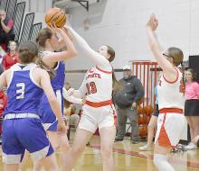 Sophomores Puridy Haley and Gracyn Painter play defense as a Lady Longhorn attempts a shot in the paint.