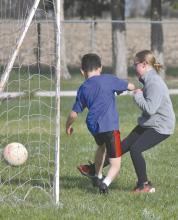 Gracyn Peterson scores a goal in her team’s final game of the season.