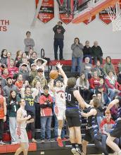 Junior Chris Fernandez puts up a narrowly-missed last second shot in overtime as the crowd watches with anticipation.