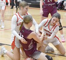 Willa Flynn and Jaylee Good get a jump ball called as they try to wrangle the ball away from Stuart’s Addie Ketteler.