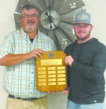 Witten Painter (right) was presented with the Athlete of the Year plaque by Graig Kinzie, owner of KBRB.