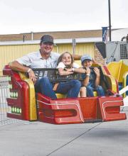 The D.C. Lynch Carnival was held on Main Street in Ainsworth June 12-14. Above is Dustin Dailey with his children Chazlee and Dawson.