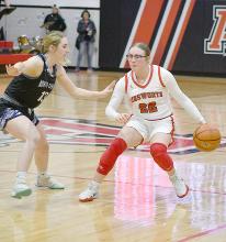 Sophomore Gracyn Painter dribbles the ball at half court as she tries to push by North Central’s Bridget Lewis.