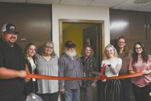 Dena Prinie cuts the ribbon in front of a Better Spirit Counseling Center located inside the Cassell Executive Offices Building on Main St. in Ainsworth.