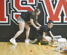 Payton Sears pushes her prom date, Ryan Kerrigan, as they play hungry hungry hippos at post prom.