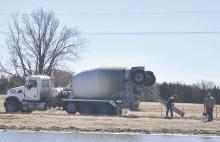 Ainsworth Ready Mix and several county employees worked together to pour the first portion of the walking path around the community fishing pond.