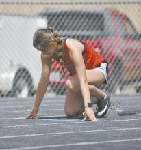 Sophomore Willa Flynn sets up in her starting blocks prior to running the 400 meter sprint. Flynn won the event, running a time of 1:02.4.6