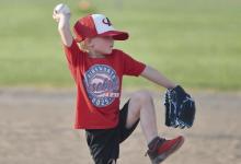 A ball is fielded by the Ainsworth Tee-Ball team and thrown to first base.