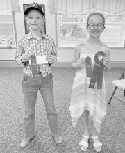 Dane Dvorak of Bassett (left) and Collins Moravec of Bassett (right) stand with their ribbons after competing in the Junior Division.