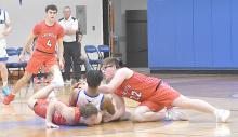 Witten Painter and Morgan Kinney dive to the floor in an attempt to recover a loose ball.
