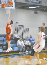 Ryan Salzman posts two for Ainsworth on a fast break against Winside in the Holiday Tournament.