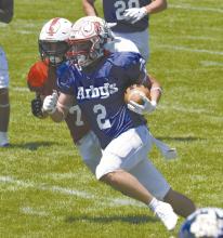 Kinney runs the football for the East team. Kinney was selected among other athletes to play in Scottsbluff June 7. The East team lost 21-7. Photo Courtesy of Susan Hoover