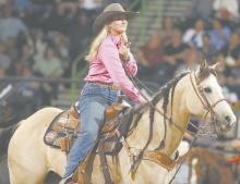 Kieley Walz praises her horse after competing in the breakaway roping.
