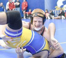 Junior Sam Titus gets near-fall points as he works his way to wining by technical fall against Todd County’s Devan White Feather.