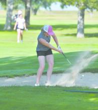 Junior Kenley Welke gets her ball out of the sand trap during the team’s home invite.