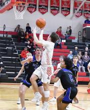 Senior Morgan Kinney takes the ball to the hoop for a layup. Kinney scored six points on the night.