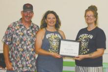 Matt and Jessica Pozehl also won the Long Pine citizens of the year award. Jessie Dillon, president of the Long Pine Chamber of Commerce, presented the couple with the award. Photo Courtesy of Lindy Sanford