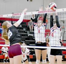 Kinsey Walz (4), Jaylee Good (2) defend at the net against the Broncos Addison Steinhauser. Willa Flynn (5) is waiting to assist if needed, but Dawgs scored the point.