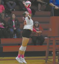 Payton Sears, one of the two freshman varsity starters, attacks a ball during the team’s pink out match against Summerland.