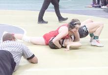 Paisley Hoffman works to pin her first competitor of the state tournament, Emily Chavez of Sandhills/Thedford.