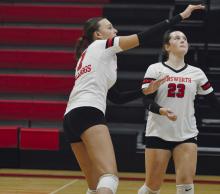 Freshman Ava Graff (7) roll spikes the ball over the net as fellow freshman Payton Sears (23) watches on.