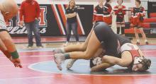 Jolyn Pozehl works to pin her opponent from Valentine as she wrestles in Ainsworth during their final regular season tournament. Pozehl will continue her wrestling career as a bobcat at Southeast Community College in Lincoln. This season, she earned both her 100th pin and 100th win of her high school career.