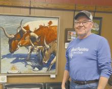 David Dorsey of Valentine stands with his acrylic painting titled “Cattle Crossing.” Dorsey won best in show at the Sand Painters Art Club’s yearly selection show.