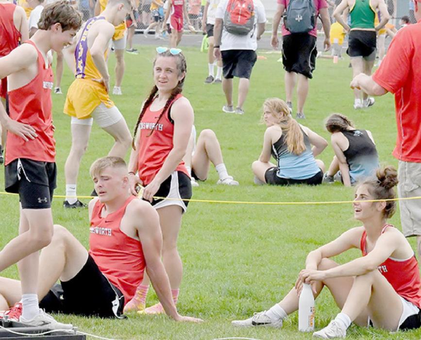Ainsworth teammates congratulate Logan Schroedl on his personal best in the 200 Meter Dash Preliminaries at District Track.