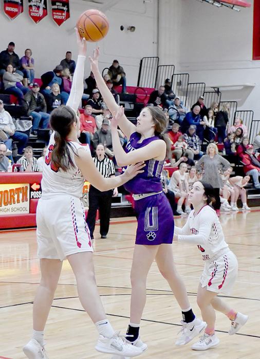 Karli Kral blocks a shot by Minden’s Makenna Betty. Kral had two blocked shots against Minden.