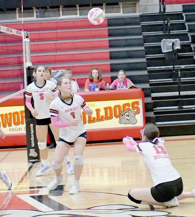 Raelynn Reagan (13) bumps the ball up to teammate Megan Jones (3) while Willa Flynn (5) is ready to assist.