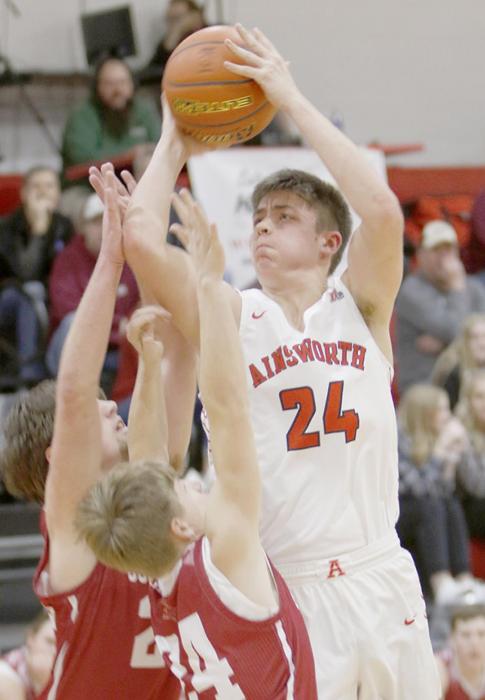 #24 sophomore Trey Appelt takes a jump-shot over a couple of Gothenburg defenders for two points.