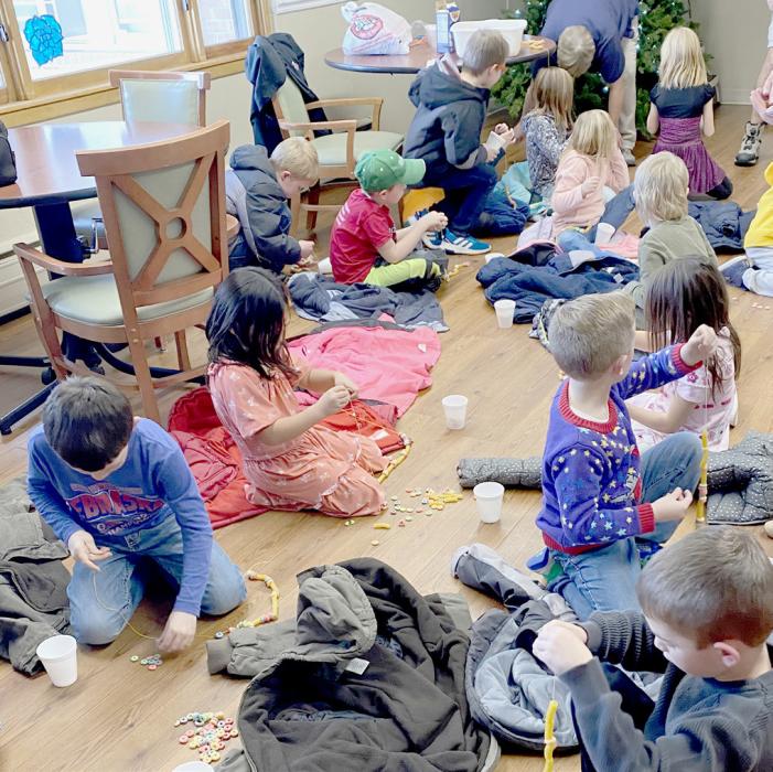 First graders from Miss Walkers and Mrs. Alberts classroom had fun stringing Fruit Loops and pasta to make garland to decorate the Christmas tree.