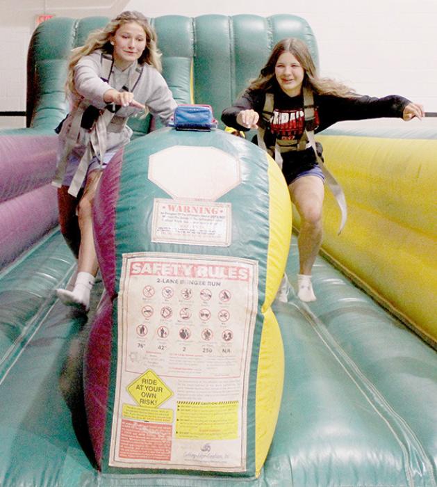 Emma Kennedy (left) and Miah Ortner (right) race for the prize during the bungee race.