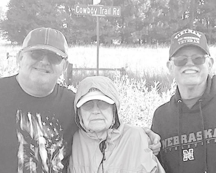 Above: Ruth Baker (center) and her sons Dean (left) and Duane (right) take a picture while on their walk on the Cowboy Trail from Long Pine to Ainsworth in late August. Below: Baker walks the Cowboy Trail with two family members. In total, 14 relatives joined her on her trek.