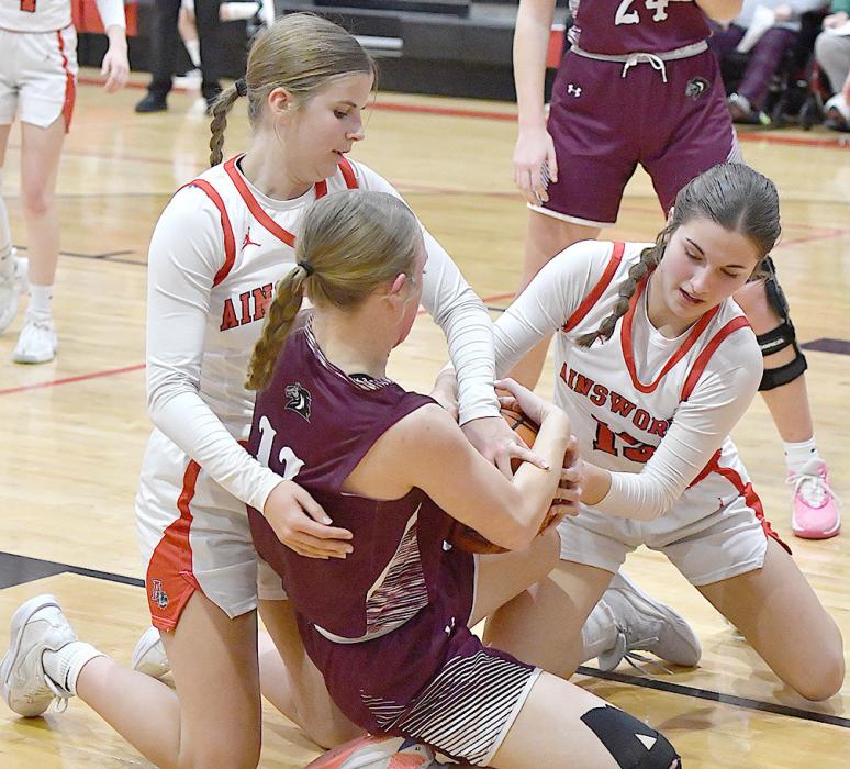 Willa Flynn and Jaylee Good get a jump ball called as they try to wrangle the ball away from Stuart’s Addie Ketteler.