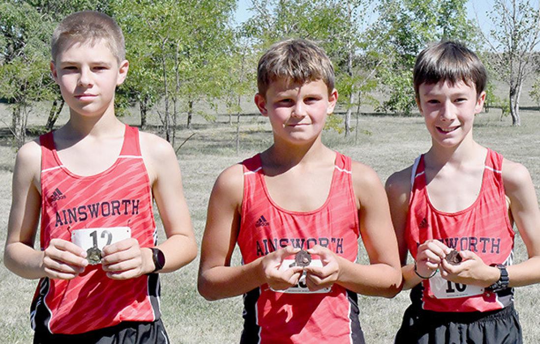 The Ainsworth Boys Middle School Team (top picture) took first place in the Middle School 1 Mile Run. Placing for Ainsworth were (left to right) Holden Beel, Zaine Evans and Ryan Kerrigan.