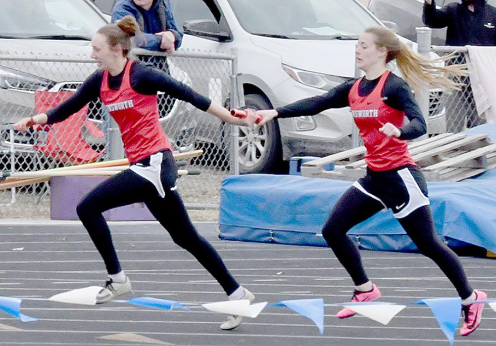 Cheyan Temple passes the baton to Cameryn Goochey in the Girls 4x100 Relay. Ainsworth took second place with a time of 54.56. West Holt won the 4x100 in a time of 52.46.