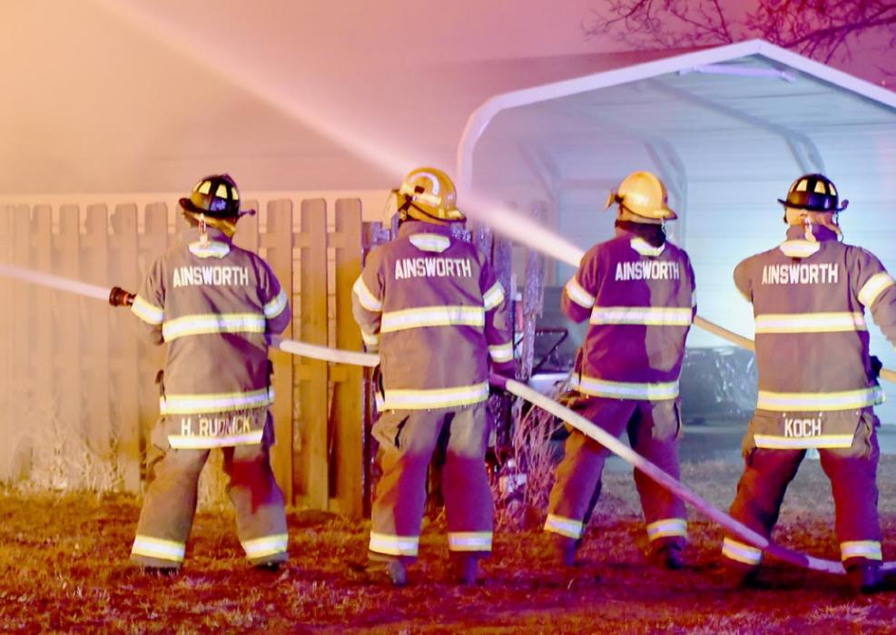 Two fire hoses with four firemen were dedicated to pouring water on the Pat Preble house located just south of the Weeks house to minimize potential damage. A large tree located between the two houses was also watered down to keep it from catching fire.