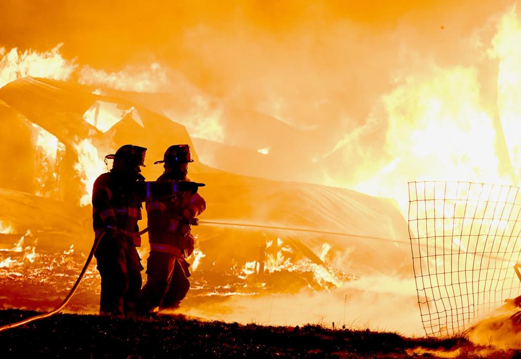 With the house and two other buildings completely engulfed by flames when they arrived on the scene, firemen were in control mode to keep the blaze from catching a house to the south and surrounding grass on fire.