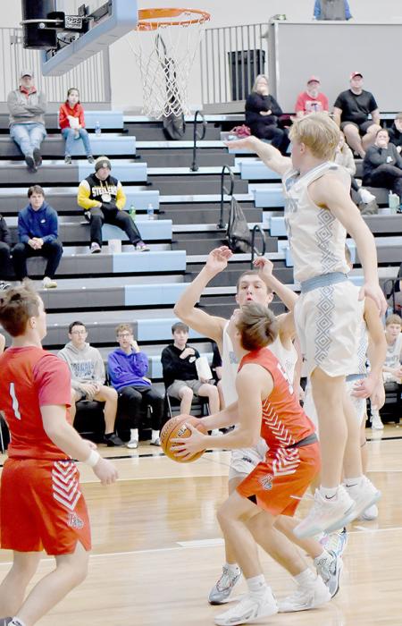 Summerland fielded a tough defense as pictured here with two Bobcat players trying to keep Traegan McNally from getting a shot off.