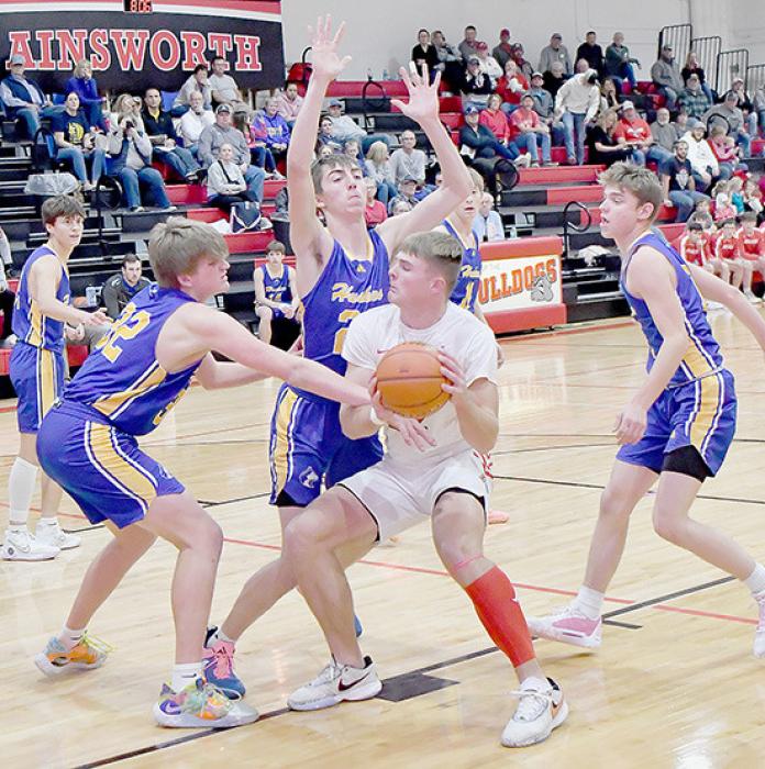 Carter Nelson draws a crowd of West Holt Huskies as he drive in a for shot.
