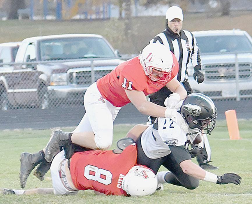 Riggin Blumenstock (11) and Traegan McNally (8) get to Hunter Luther for a loss and forcing a Jaguar punt from their own end zone.