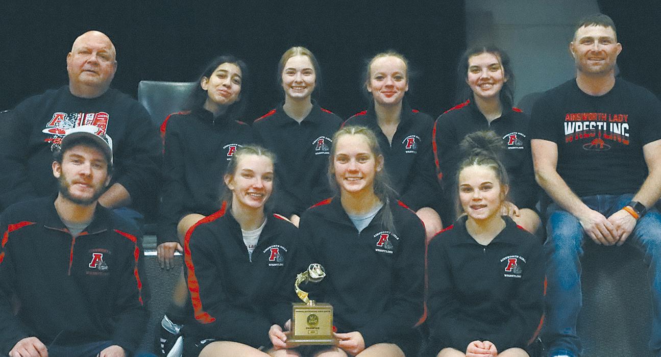 The Ainsworth Girls Wrestling Team brought home first place as a team from the 2025 Sandhills/Thedford Invitational held in Dunning on January 25th. Team members are (Back Row Left to Right) Coach Todd Pollock, Maya Macias, Sydney Hoffman, Lynley Leonard, Braylin Rudnick, Coach Ryan Hoffman; (Front Row Left to Right) Coach Oren Pozehl, Jolyn Pozehl, Megan Jones and Paisley Hoffman.