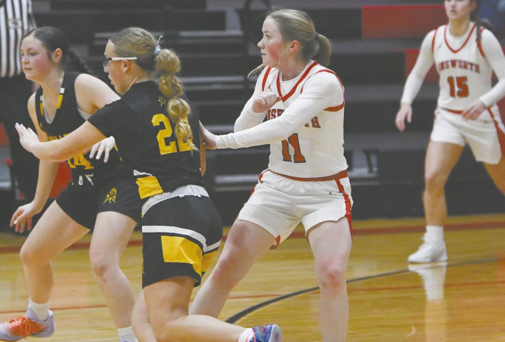 Ainsworth’s Kenley Welke (11) plays defense on Mullen’s Riley Hegland (22).