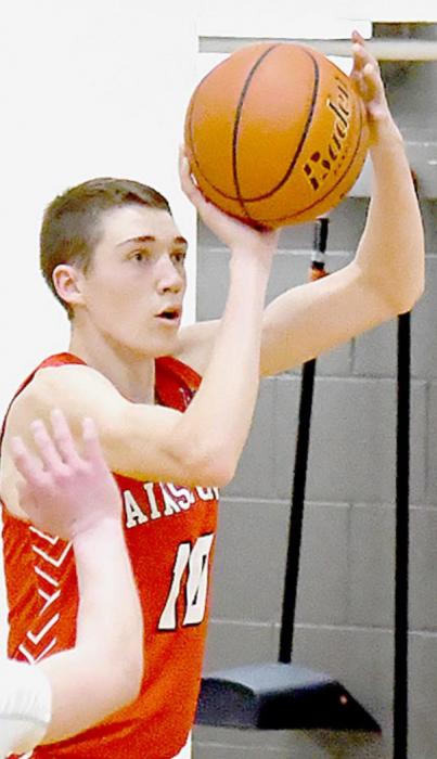 Senior Ty Schlueter shoots for two of his four points. He also grabbed two rebounds and stole the ball twice.
