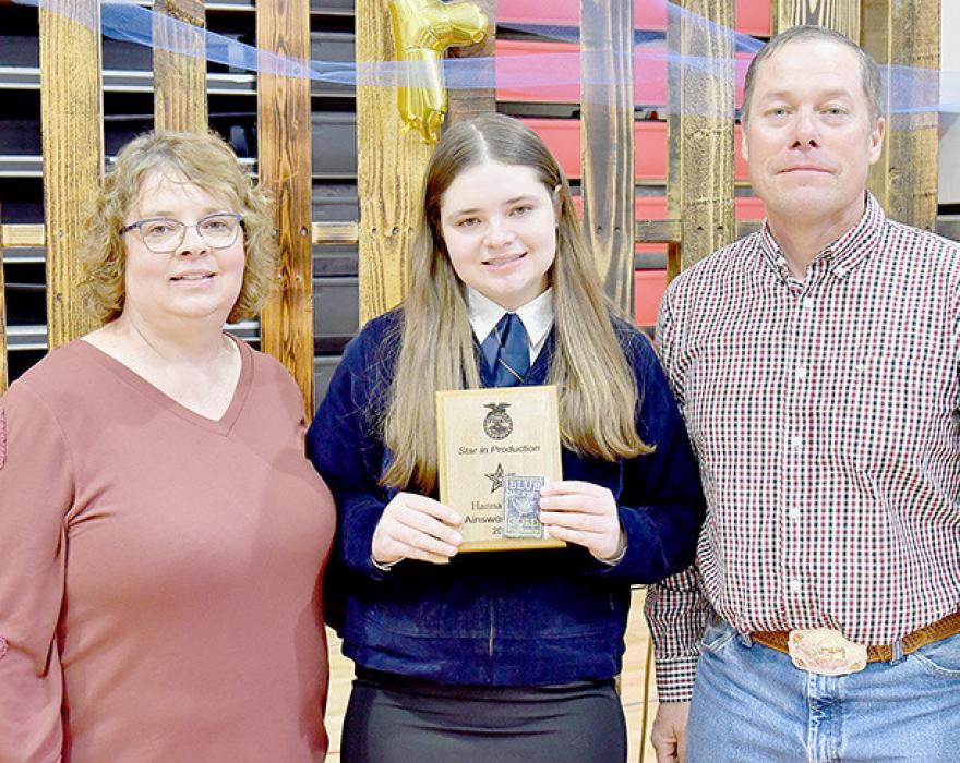 Hanna Beel (center) was presented the Star Chapter Award in Agricultural Production. She was accompanied by her parents Mary and Henry Beel.