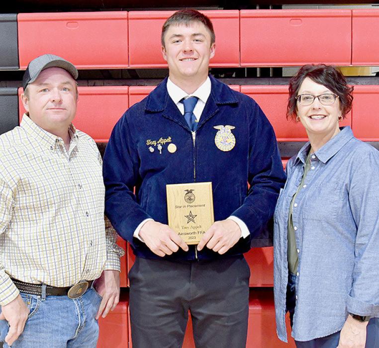 The Star Chapter Award in Agricultural Placement was presented to Trey Appelt (center). He stands with his parents Jason and Michelle Appelt.