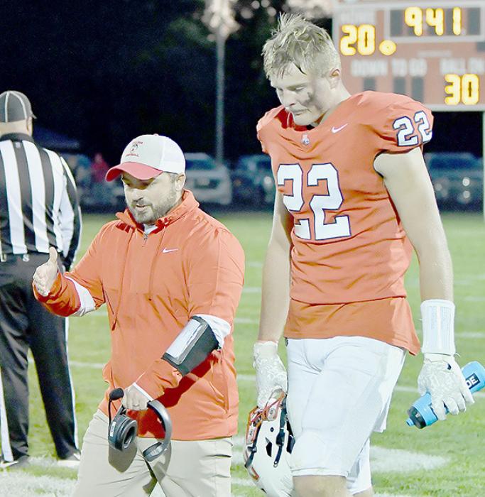 Ainsworth Head Coach Jessi Owen walks down the sideline with Carter Nelson following Nelson’s 79 yard touchdown run. This was Nelson’s second 79 yard touchdown run in as many games.