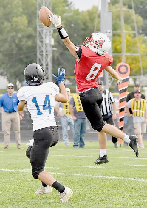Traegan McNally goes high to break up a Cougar pass in Ainsworth’s Homecoming game.