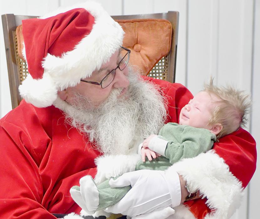 Sawyer Shifflet snuggled with Santa Claus while he was in Long Pine.